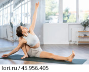 Young woman practicing hatha yoga in studio. Стоковое фото, фотограф Яков Филимонов / Фотобанк Лори