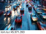 Top view of a busy city traffic at night, featuring moving cars in motion blur. Bright lights, and a vibrant cityscape. Blurred background. Стоковое AI-изображение, AI-художник Михаил Строгалев / Фотобанк Лори