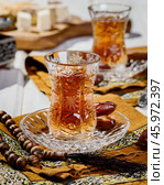 Azerbaijani black tea in armudu tea glass. Atmosphere of Baku and Eastern traditions. Oriental cuisine. Cozy atmosphere in the caucasus cafe. Стоковое фото, фотограф Андрис Салминьш / Фотобанк Лори