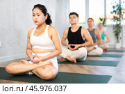 Young Asian lady performs comfortable lotus asana-Padmasana-Siddhasana pose. Стоковое фото, фотограф Яков Филимонов / Фотобанк Лори