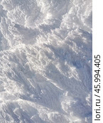 Vertical winter background with snow-covered mountain surface showcasing intricate patterns and textures. Стоковое фото, фотограф Александра Селина / Фотобанк Лори