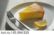 Delicious Slice of Lemon Cake Beautifully Presented on a Charming Plate and Ready to Enjoy. Delectable portion of rich lemon cake is garnished with powdered sugar and is charmingly served with a fork. Стоковое AI-видео, аниматор Марина Демидюк / Фотобанк Лори