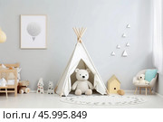 Cozy scandinavian style kids room interior with teepee tent and teddy bear. Стоковое AI-изображение, AI-художник Иван Рябоконь / Фотобанк Лори