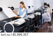 Print worker controlling printing process on modern offset machine in print shop. Стоковое фото, фотограф Яков Филимонов / Фотобанк Лори