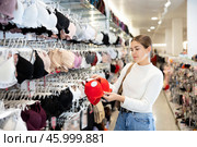 Young girl choosing convenient bra in clothing store. Стоковое фото, фотограф Яков Филимонов / Фотобанк Лори