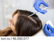 Hands of trichologist performing injections into scalp to female patient. Стоковое фото, фотограф Яков Филимонов / Фотобанк Лори