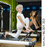 Mature woman actively doing Pilates exercises. Стоковое фото, фотограф Яков Филимонов / Фотобанк Лори