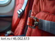 Empty airplane seat with focus on fastened buckle of seatbelt. Стоковое AI-изображение, AI-художник Иван Рябоконь / Фотобанк Лори