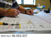 Architect reviewing blueprints and making corrections with pencil. Стоковое AI-изображение, AI-художник Иван Рябоконь / Фотобанк Лори