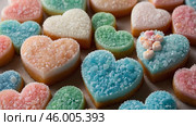 Colorful heart-shaped candies on display featuring pastel shades and granular textures in a vibrant arrangement. Стоковое AI-изображение, AI-художник Сергей Толмачёв / Фотобанк Лори