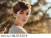 Young stylish woman with pixie cut posing in nature. Стоковое AI-изображение, AI-художник Иван Рябоконь / Фотобанк Лори