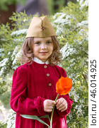 The concept of the May 9th holiday. Portrait of a beautiful girl in a military cap with a tulip flower. Celebration of Victory Day 1941-1945. Стоковое фото, фотограф Photojuli / Фотобанк Лори