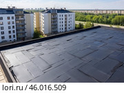 Workers are covering roof with roofing felt and bitumen. Стоковое AI-изображение, AI-художник Иван Рябоконь / Фотобанк Лори