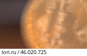 Gold Bitcoin Symbol beautifully placed on a Wooden Surface. Close up. Стоковое видео, видеограф Степанов Григорий / Фотобанк Лори
