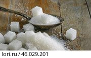 Sugar pile in a metal spoon on a wood surface. White granulated sugar and cubes. Natural seasoning. Refined sugar poured on wooden rustic table. Sugary sand. Cooking, cosmetology, spa services concept. Стоковое AI-видео, аниматор Марина Демидюк / Фотобанк Лори
