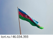 National flag state Azerbaijan is fluttering in wind against background blue sky. Стоковое фото, фотограф Spirit River / Фотобанк Лори