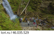 Outdoor activities. Tourists take pictures of the beautiful waterfall in Sochi National Park. Активный отдых на природе. Туристы фотографируют красивый водопад в Сочинском национальном парке. Редакционное видео, видеограф Валерий Тесаков / Фотобанк Лори