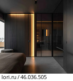 A modern bedroom interior, designed in a minimalist style. The room is distinguished by dark shades, smooth surfaces and elegant lighting. Along one of the walls there is a built-in warm yellow backlight, which emphasizes the lines of the interior and creates an atmosphere of coziness. In the foreground you can see the edge of the bed with a laconic textile covering, as well as elements of the built-in wardrobe with glossy facades. The space looks spacious, stylish and functional, with an emphasis on modern design solutions. Стоковое AI-изображение, AI-художник Анна Кривицкая / Фотобанк Лори
