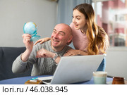 Happy married couple, attentive examines a globe. Стоковое фото, фотограф Яков Филимонов / Фотобанк Лори