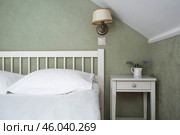 A bed with white sheets and a vintage Provence-style bedside table in a hotel room or a home bedroom. Space for the text. Enjoying the morning concept. Стоковое фото, фотограф Photojuli / Фотобанк Лори