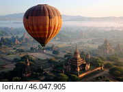 Hot air balloon flying over buddhist temples in bagan at sunrise. Стоковое AI-изображение, AI-художник Иван Рябоконь / Фотобанк Лори
