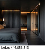 A modern bedroom in dark tones, designed in a minimalist and high-tech style. The main elements of the interior include black walls with vertical relief panels, built-in warm lighting that creates a cozy atmosphere, as well as a large low bed with dark bed linen. The interior is complemented by glass cabinets with lighting and finishing in warm wooden tones. On the left side of the room you can see a laconic pendant lamp and decorative elements in the form of dried flowers. The space looks stylish, discreet and elegant. Стоковое AI-изображение, AI-художник Анна Кривицкая / Фотобанк Лори
