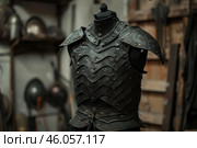 Black leather medieval armor standing in a workshop. Стоковое AI-изображение, AI-художник Иван Рябоконь / Фотобанк Лори