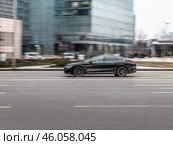 BYD Han DM plug-in hybrid car driving down the street. Редакционное фото, фотограф Константин Григорьев / Фотобанк Лори