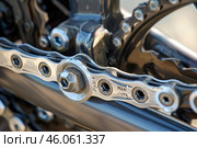 Close up of bicycle chainring and crankset showing detail of chain. Стоковое AI-изображение, AI-художник Иван Рябоконь / Фотобанк Лори