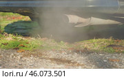 Thick plumes of exhaust billowing from the vehicle's tailpipe, obscuring the surrounding natural landscape. Close-up. Slow motion. The poisoning of the environment by poisonous gases of cars. Стоковое видео, видеограф Воловодов Владимир / Фотобанк Лори