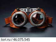 Steampunk goggles resting on dark surface, embracing retrofuturistic style. Стоковое AI-изображение, AI-художник Иван Рябоконь / Фотобанк Лори