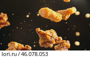 Grilled chicken legs, drumsticks falling in the air, isolated on black background, food concept. Crispy fried chicken nuggets levitation. Roast chicken strips, pieces flying in the air. Dynamic scene. Стоковое AI-видео, аниматор Марина Демидюк / Фотобанк Лори