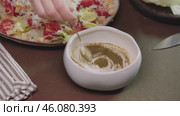 Chopped greens are carefully mixed with sauce, which is prepared on basis of mayonnaise with addition of Greek yogurt and sour cream. Стоковое видео, видеограф Strunov David / Фотобанк Лори