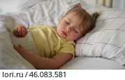 Peaceful adorable baby sleeping on a bed at home. Slumbering little child. Two years old girl sleeps peaceful at domestic room interior background. Serene dream. Cute face close up. Deep kid slumber. Стоковое видео, видеограф Марина Демидюк / Фотобанк Лори