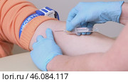 Close up hand of doctor or medical nurse in blue latex gloves takes blood sample from a patient's vein with syringe, tourniquet. Taking blood from a woman for laboratory. Редакционное видео, видеограф Ирина Михайличенко / Фотобанк Лори