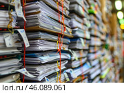 Stacked office files creating a wall of paperwork. Стоковое AI-изображение, AI-художник Иван Рябоконь / Фотобанк Лори