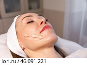 Woman on a couch with gel on her face before beauty treatment, removing pigmentation at cosmetic clinic. Phototherapy, photorejuvenation, IPL in a beauty salon. Skin care concept. High quality photo. Стоковое фото, фотограф Ирина Михайличенко / Фотобанк Лори