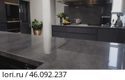 Kitchen with a countertop made of granite and a black cabinet. Стоковое AI-видео, аниматор Sergey Grishin / Фотобанк Лори