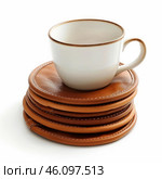White coffee cup standing on stack of leather coasters. Стоковое AI-изображение, AI-художник Иван Рябоконь / Фотобанк Лори