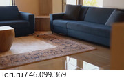 Blue couch sits in a living room with a rug underneath it. Стоковое AI-видео, аниматор Sergey Grishin / Фотобанк Лори