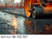 Road roller compacting wet asphalt at sunset during road construction. Стоковое AI-изображение, AI-художник Иван Рябоконь / Фотобанк Лори