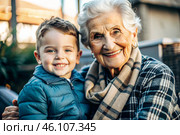 A happy family, a child and a grandmother hug on the street in the park, happy and contented. A grandmother who hugs her grandson, showing love. Стоковое AI-изображение, AI-художник Photojuli / Фотобанк Лори