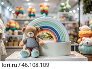 Beautiful colorful showcase of a children's store with a rainbow and a teddy bear. The concept of shopping and shopping for children's goods. Стоковое AI-изображение, AI-художник Photojuli / Фотобанк Лори