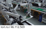 Factory with many robots working on a green conveyor belt. Стоковое AI-видео, аниматор Sergey Grishin / Фотобанк Лори