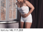Woman suffering from menstrual pain at home. Стоковое фото, фотограф Станислав Тарко / Фотобанк Лори