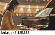 Talented musician playing a grand piano on a stage in a concert hall. Стоковое AI-видео, аниматор Юрий Поздников / Фотобанк Лори