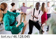 Woman dances incendiary boogie woogie with African man partner during choreography lesson. Стоковое фото, фотограф Яков Филимонов / Фотобанк Лори