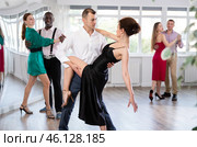 Woman dances incendiary tango with man partner during choreography lesson. Стоковое фото, фотограф Яков Филимонов / Фотобанк Лори