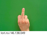 Abusive gesture fuck on chromakey. Male hand shows middle finger, offensive gesture isolated on green background. Fuck You concept. Close Up. Bad expression, provocation. Rude attitude. Fuck off sign. Стоковое фото, фотограф Марина Демидюк / Фотобанк Лори