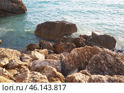 Waves gently crash against the rugged rocks while the sun sets over the horizon. Experience the serene beauty of this coastal location filled with natural wonders. Canj, Montenegro, Adriatic sea (2024 год). Стоковое фото, фотограф Юлия Петровская / Фотобанк Лори